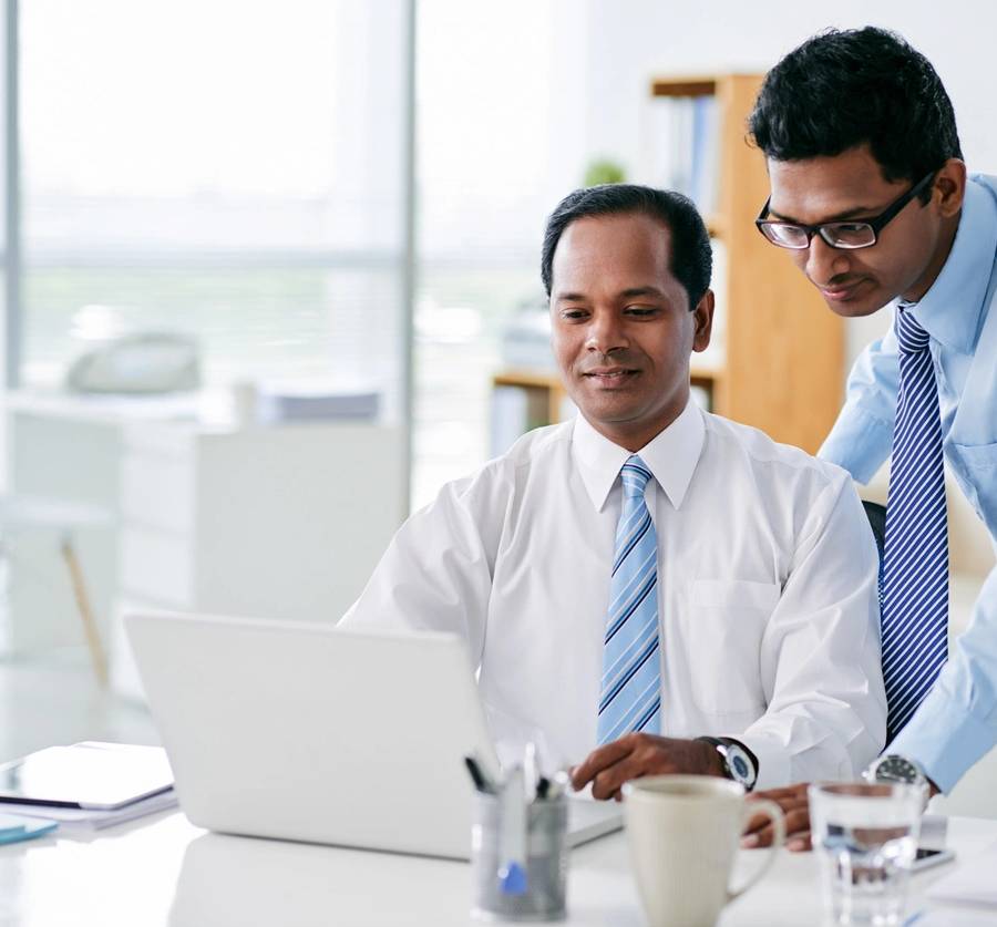 Businessman holding a tablet with futuristic digital icons and globe.