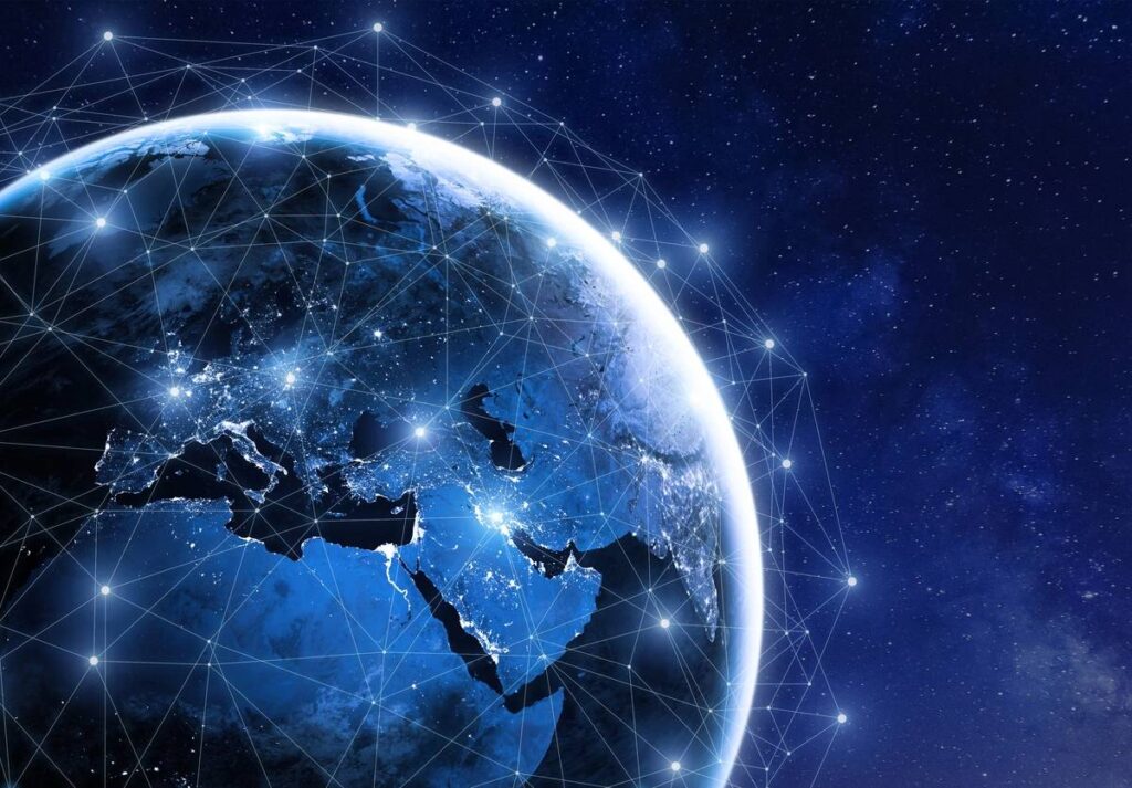 Businessman holding a tablet with futuristic digital icons and globe.