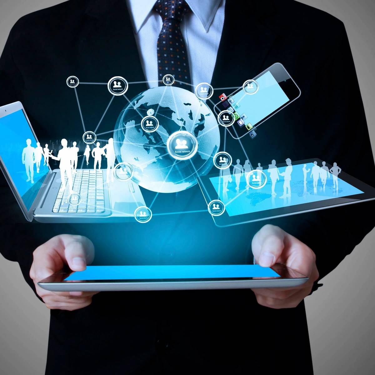 Businessman holding a tablet with futuristic digital icons and globe.